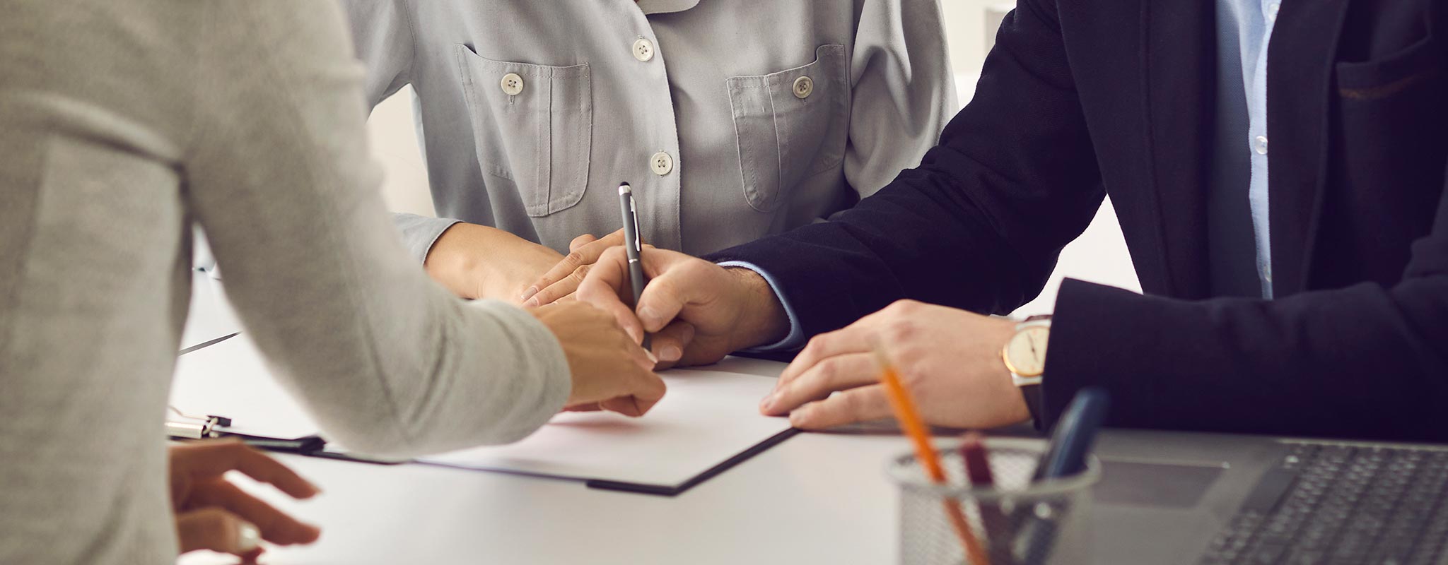 Man signing a financial document.